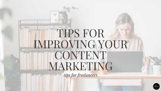 A photo of a freelancer sitting behind a computer working on her content writing and marketing (probably). There's a full bookshelf in the background with all the spines turned backwards.